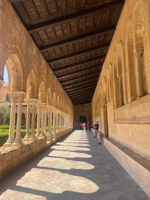 a hallway of a building with people walking down it at Cut' Home in Monreale