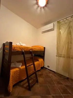 a room with two bunk beds and a window at Cut' Home in Monreale