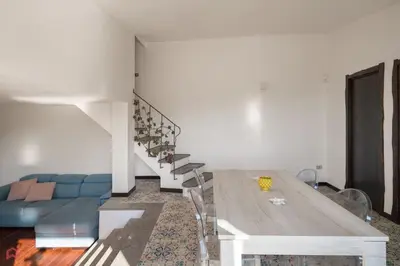 a living room with a table and a blue couch at Stunning seaview villa in Altavilla Milicia