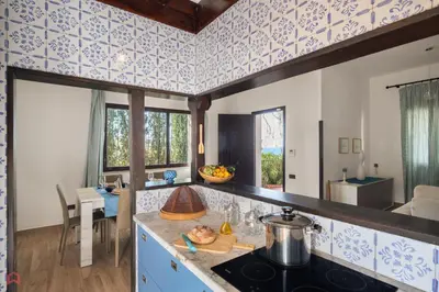 a kitchen with blue and white tiles on the walls at Stunning seaview villa in Altavilla Milicia