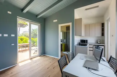 a kitchen with a table with a laptop on it at Sweet Sicily Apartments in Carini