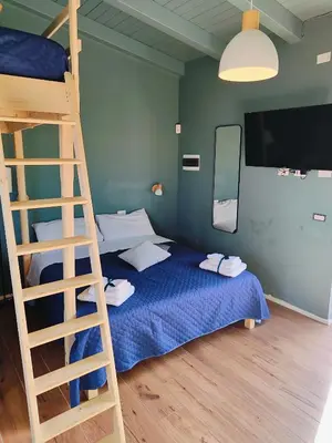 a bedroom with a bunk bed and a ladder at Sweet Sicily Apartments in Carini
