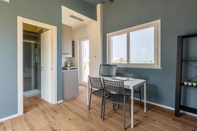 a kitchen and dining room with a table and chairs at Sweet Sicily Apartments in Carini