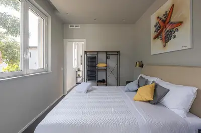 a large bed in a room with a window at Sweet Sicily Apartments in Carini