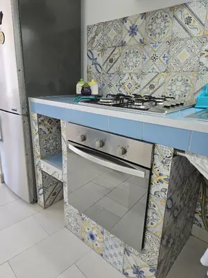 a kitchen with a white table and chairs and a kitchen with a refrigerator at CASA CASCIOTTO in Palermo