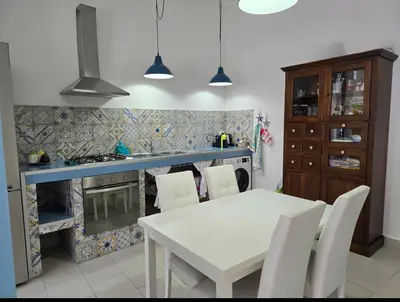 a living room with a blue couch and a bed at CASA CASCIOTTO in Palermo