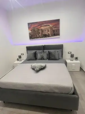 a bedroom with a large bed with purple lights at La casetta di salvuccio in Palermo