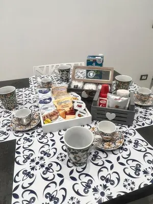 a table with a white and blue patterned table cloth at La casetta di salvuccio in Palermo