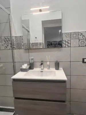 a bathroom with a sink and a mirror at La casetta di salvuccio in Palermo