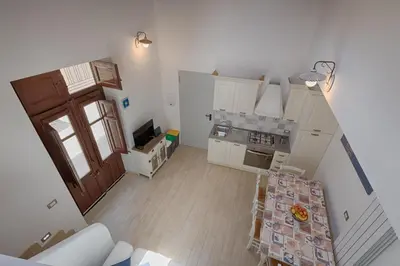 an overhead view of a kitchen with a table in a room at GuestHost - Il Piccolo Scrigno - Comfy & Central Studio x5 in Castellammare del Golfo