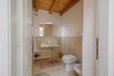 a bathroom with a white toilet and a sink at GuestHost - Il Piccolo Scrigno - Comfy & Central Studio x5 in Castellammare del Golfo