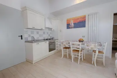 a kitchen and dining room with a table and chairs at GuestHost - Il Piccolo Scrigno - Comfy & Central Studio x5 in Castellammare del Golfo