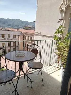 a table and chairs on a balcony with a view at BBX Palermo Centro in Palermo