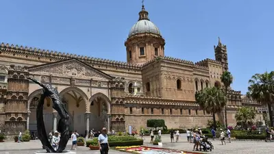 a large building with a statue in front of it at BBX Palermo Centro in Palermo