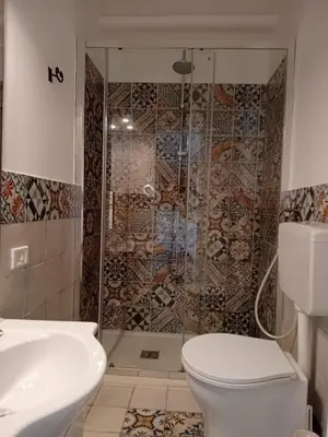 a bathroom with a shower with a toilet and a sink at BBX Palermo Centro in Palermo