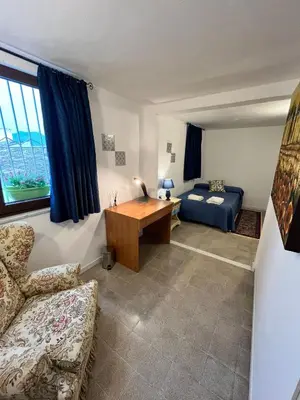 a living room with a couch and a desk at Mille Lire Peppe's Home in Palermo