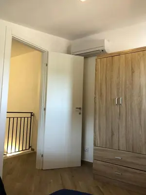 a bedroom with a closet and a large wooden cabinet at Scopello Guidaloca Villas in Scopello