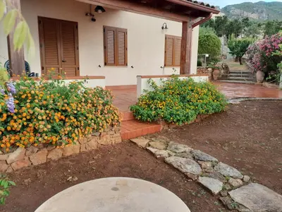 a house with some flowers in front of it at Mediterraneo in Castellammare del Golfo