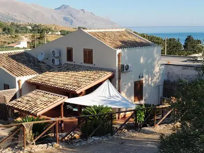 a white house with a tent in front of it at Mediterraneo in Castellammare del Golfo