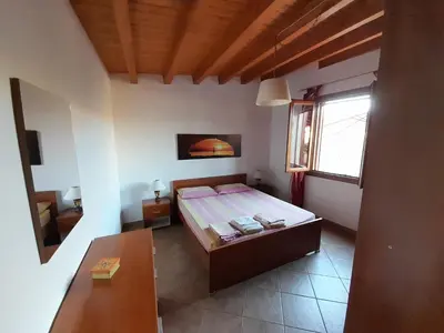 a small bedroom with a bed and a window at Mediterraneo in Castellammare del Golfo