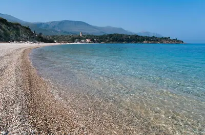 a beach with clear water and a rocky shore at Villa Saracena in Castellammare del Golfo