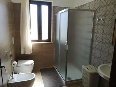 a bathroom with a shower and a toilet and a sink at Villa Saracena in Castellammare del Golfo