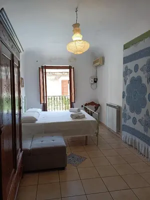 a bedroom with a large bed and a window at Quiet and comfortable apartment in Palermo city centre in Palermo