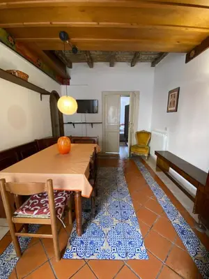 a living room with a wooden table and a rug at Quiet and comfortable apartment in Palermo city centre in Palermo