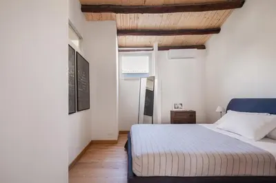a bedroom with a bed and a wooden ceiling at Conte Ruggero Apartment by DomuSicily in Palermo