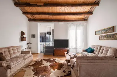 a living room with two couches and a tv at Conte Ruggero Apartment by DomuSicily in Palermo