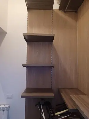 a closet with wooden shelves in a room at GIORGISA in Palermo