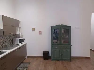 a green cabinet in the corner of a kitchen at GIORGISA in Palermo