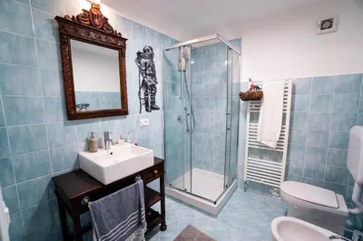 a bathroom with a sink and a shower and a toilet at Solemar Sicilia - Palazzo Vetrano Centro Storico in Palermo