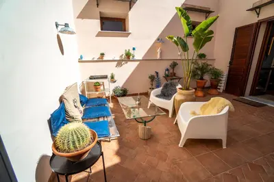 a living room filled with lots of potted plants at Solemar Sicilia - Palazzo Vetrano Centro Storico in Palermo