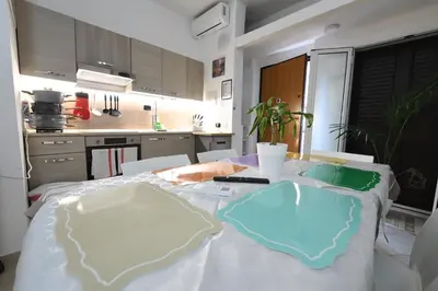 a kitchen with a table with a white table cloth at Phoenix Apartment in Terrasini