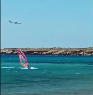 a person windsurfing in the water in the ocean at Phoenix Apartment in Terrasini