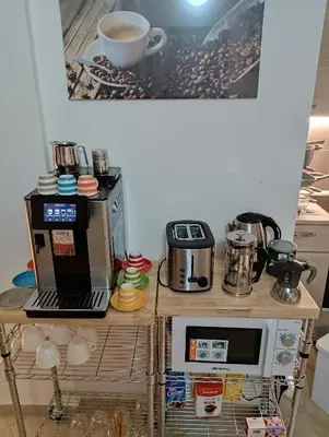 a table with a coffee maker and a microwave at Phoenix Apartment in Terrasini