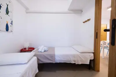 a room with two beds with towels on them at Apartment on the Beach - Large Terrace in Alcamo