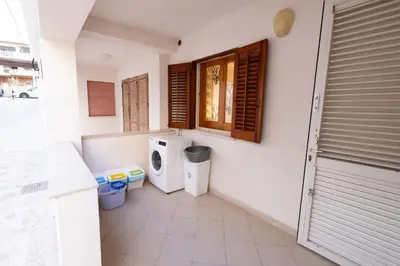 a laundry room with a washing machine and a window at Apartment on the Beach - Large Terrace in Alcamo