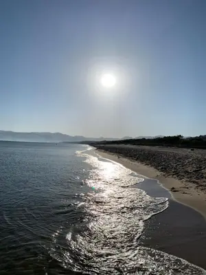 a beach with the sun shining on the water at Apartment on the Beach - Large Terrace in Alcamo