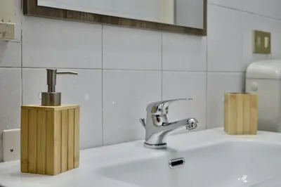 a bathroom sink with a faucet and a mirror at Villa Rosetta vacanze al mare in Carini