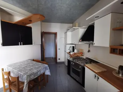 a kitchen with a table and a dining room at La Casa del Capo in Palermo