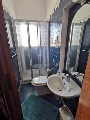 a bathroom with a sink and a toilet at La Casa del Capo in Palermo