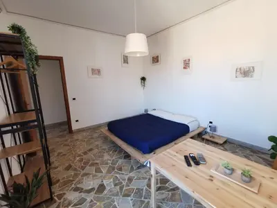 a bedroom with a bed and a wooden table at La Casa del Capo in Palermo