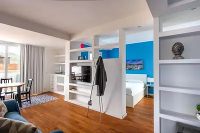 a living room with a bed and a dining room at Vista sulle Cupole by Wonderful Italy in Palermo