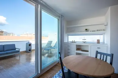 a kitchen and dining room with a table and a window at Vista sulle Cupole by Wonderful Italy in Palermo