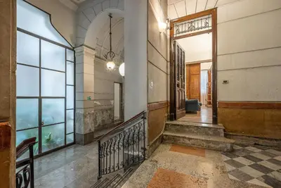 an empty hallway of a building with a door and stairs at Lea's Luxury Art Apartment by Wonderful Italy in Palermo
