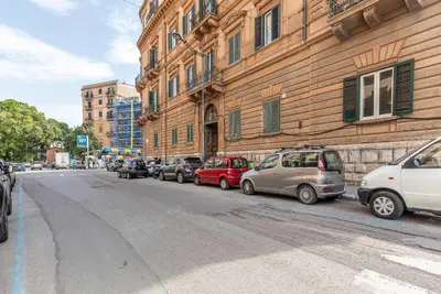 a row of cars parked on a street next to a building at Lea's Luxury Art Apartment by Wonderful Italy in Palermo