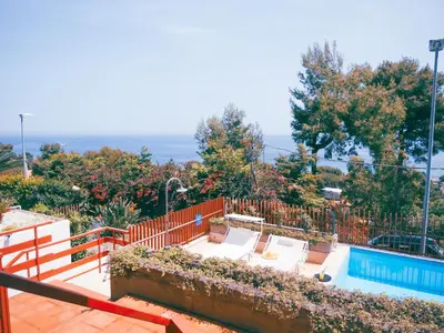 a balcony with a swimming pool and a fence at Sea apartment & pool 2 in Palermo