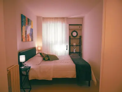 a bedroom with a bed in a pink room at Sea apartment & pool 2 in Palermo